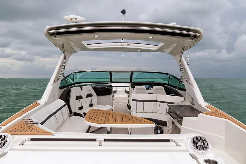 Slide: The Image of Manufacturer Provided Image: 2019 Sea Ray SLX 350 luxury boat interior with teak accents on open water. - 11