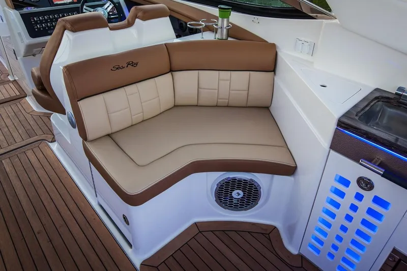 Slide: The Image of Manufacturer Provided Image: 2019 Sea Ray SLX 350 boat interior with tan leather seating and wood flooring. - 12