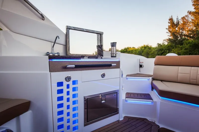 Slide: The Image of Manufacturer Provided Image: 2019 Sea Ray SLX 350 boat interior with kitchenette and seating area. - 14
