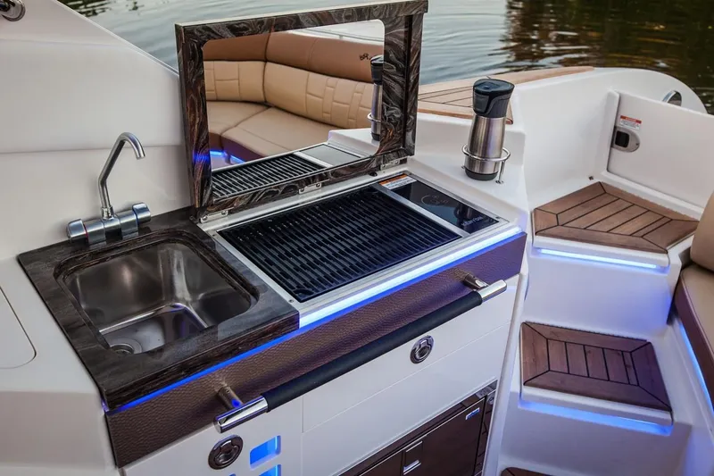 Slide: The Image of Manufacturer Provided Image: 2019 Sea Ray SLX 350 boat interior with sink, grill, and seating area. - 15