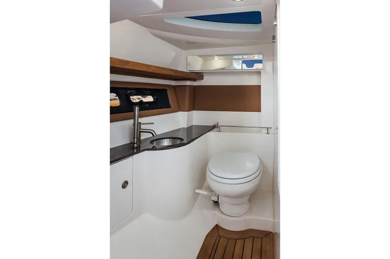 Slide: The Image of Manufacturer Provided Image: 2019 Sea Ray SLX 350 boat bathroom with modern fixtures and wooden accents. - 19