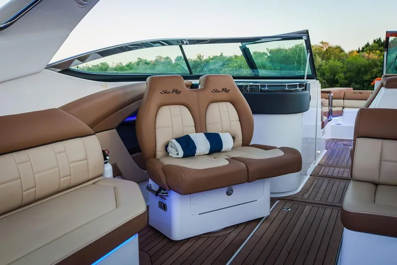 Slide: The Image of Manufacturer Provided Image: 2019 Sea Ray SLX 350 boat interior with tan leather seats and wooden deck. - 9