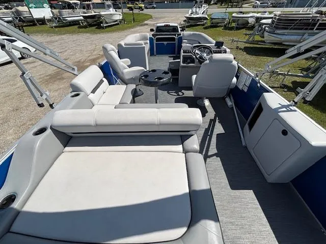 Slide: The Image of 2022 Sweetwater 2286 pontoon boat interior with plush seating and steering console. - 10
