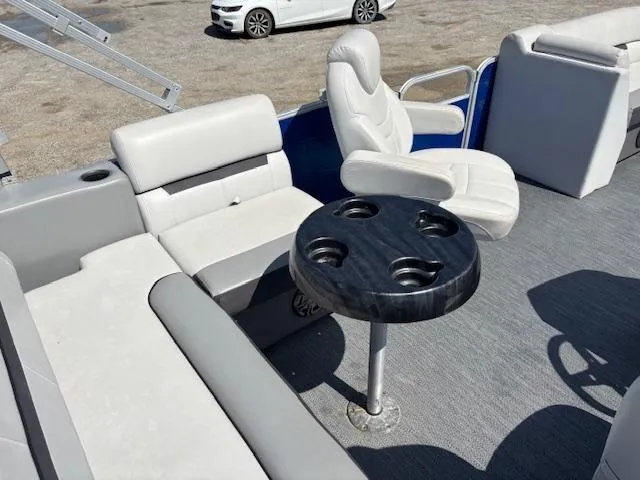 Slide: The Image of 2022 Sweetwater 2286 boat interior with seating and cup holder table. - 12