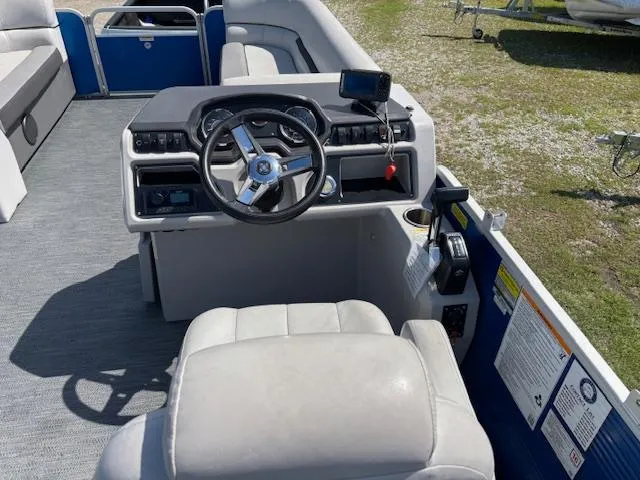Slide: The Image of 2022 Sweetwater 2286 boat interior with steering wheel and control panel. - 13