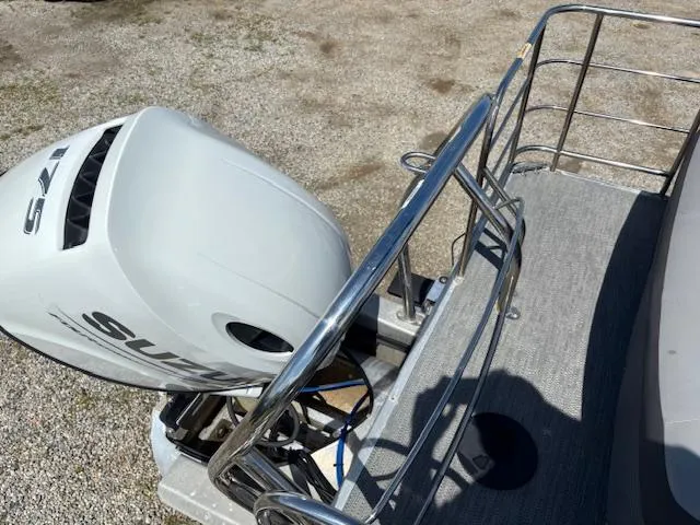 Slide: The Image of 2022 Sweetwater 2286 boat with Suzuki outboard motor, viewed from the deck. - 25