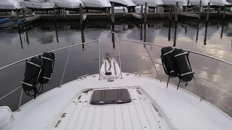 Slide: The Image of 1986 Carver 36 Mariner boat docked at marina, view from bow. - 2