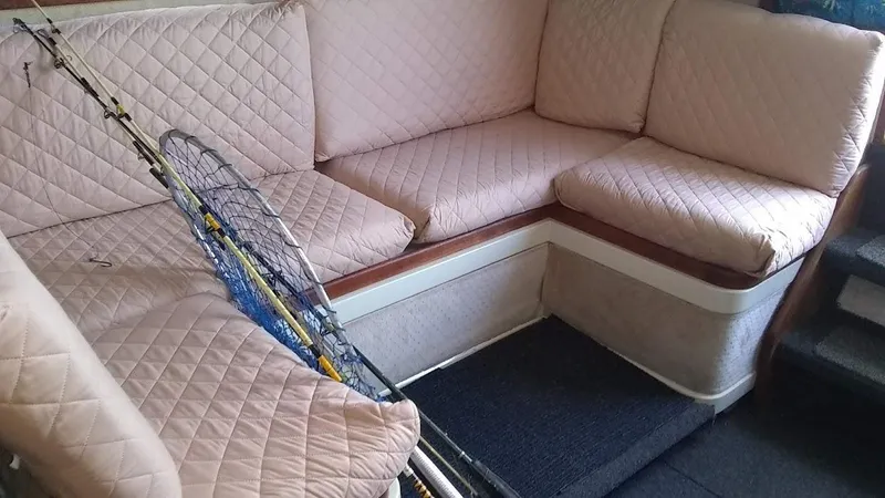 Slide: The Image of Interior of 1986 Carver 36 Mariner with fishing gear on quilted seating. - 4