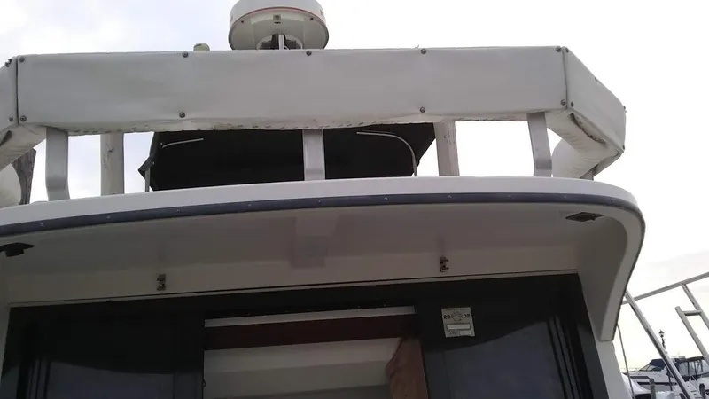 Slide: The Image of 1986 Carver 36 Mariner boat, upper deck view with radar equipment. - 3