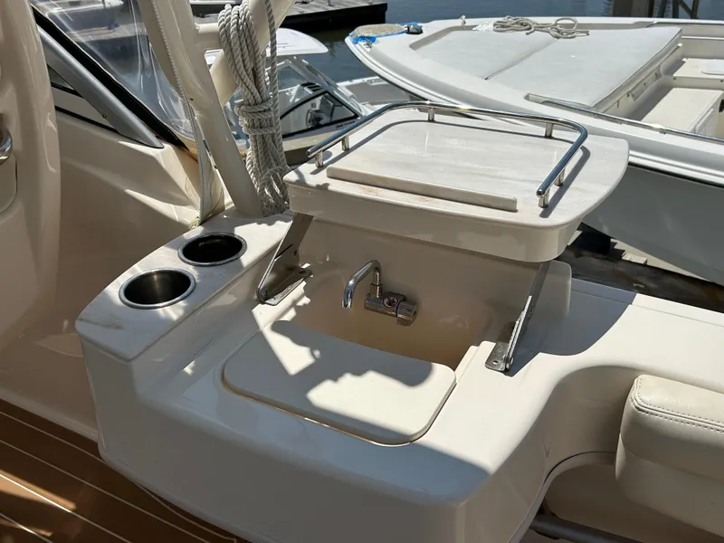 Slide: The Image of 2018 Grady-White Freedom 235 boat interior with sink and cup holders. - 11