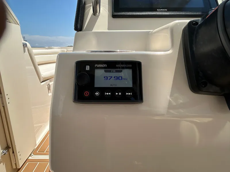 Slide: The Image of Fusion MS-NRX300 radio on 2018 Grady-White Freedom 235 boat dashboard. - 19