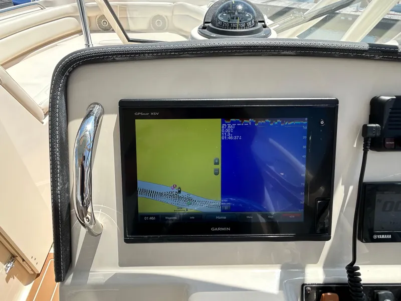 Slide: The Image of 2018 Grady-White Freedom 235 boat dashboard with Garmin GPS and compass. - 20