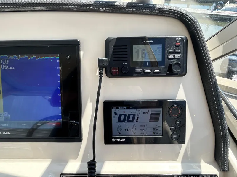 Slide: The Image of Dashboard of a 2018 Grady-White Freedom 235 with Garmin and Yamaha displays. - 21