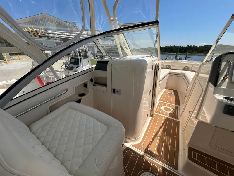 Slide: The Image of 2018 Grady-White Freedom 235 boat interior with luxurious seating and wood-style flooring. - 25