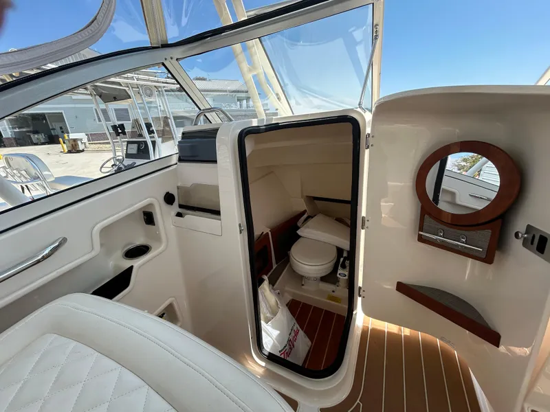 Slide: The Image of 2018 Grady-White Freedom 235 boat interior with cabin and toilet. - 26