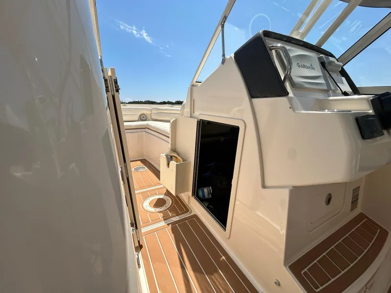 Slide: The Image of 2018 Grady-White Freedom 235 boat interior with open storage and wooden flooring. - 28