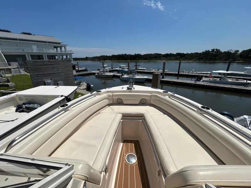 Slide: The Image of 2018 Grady-White Freedom 235 boat docked at marina, sunny day, waterfront view. - 29
