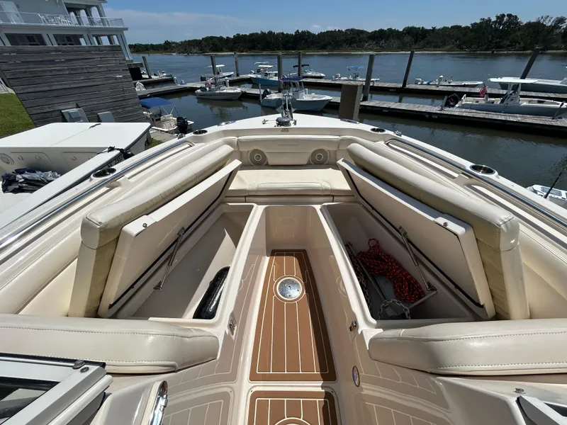 Slide: The Image of 2018 Grady-White Freedom 235 boat interior with open storage compartments at marina. - 31