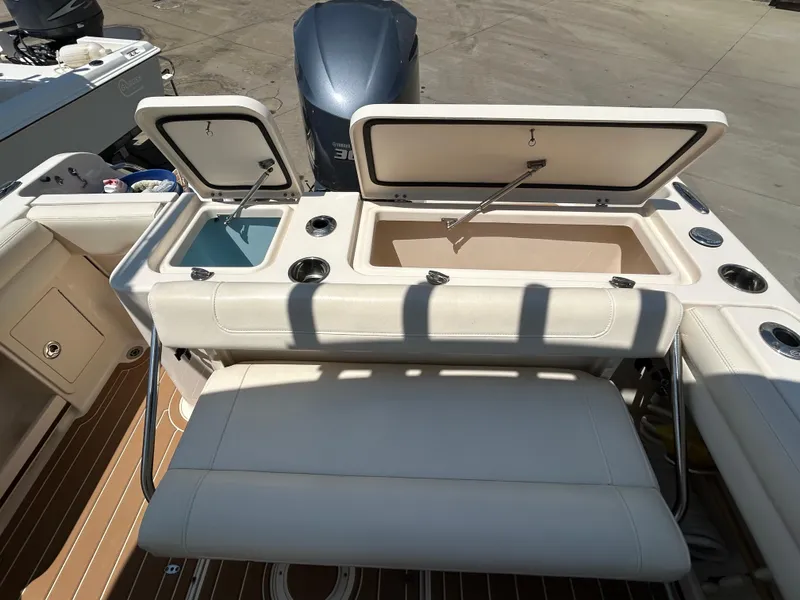 Slide: The Image of 2018 Grady-White Freedom 235 boat with open storage compartments and seating. - 9