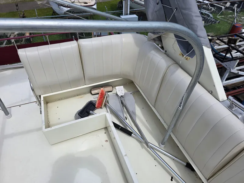 Slide: The Image of 1988 Marinette 37 Motor Yacht deck with white seating and cleaning tools. - 14