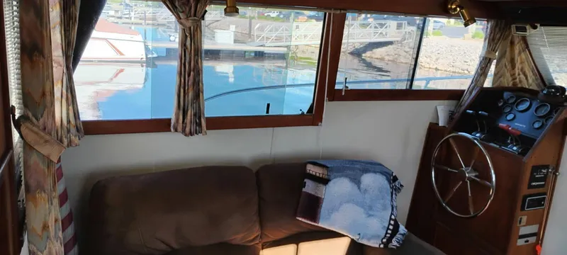 Slide: The Image of Interior of 1988 Marinette 37 Motor Yacht with cozy seating and helm view. - 19