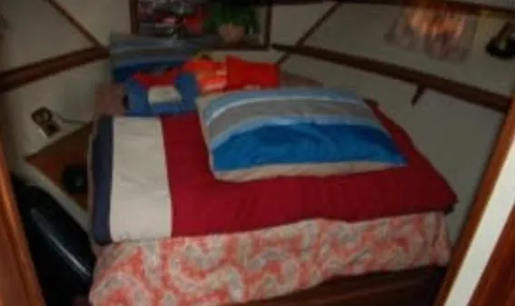 Slide: The Image of Cozy bedroom inside 1988 Marinette 37 Motor Yacht with colorful bedding and pillows. - 22