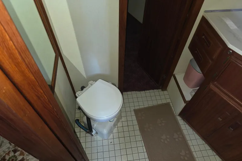 Slide: The Image of Bathroom interior of 1988 Marinette 37 Motor Yacht with toilet and wooden cabinetry. - 40
