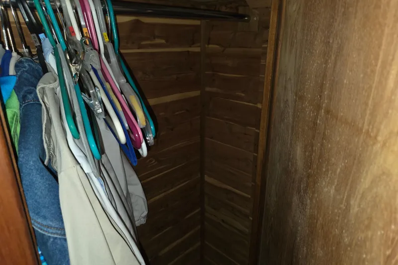 Slide: The Image of Clothes hanging in a wooden closet on a 1988 Marinette 37 Motor Yacht. - 54
