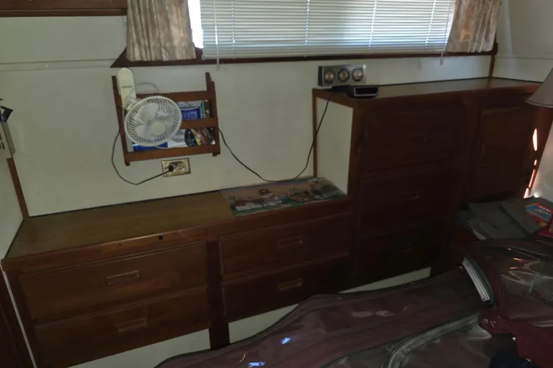 Slide: The Image of 1988 Marinette 37 Motor Yacht interior with wooden cabinets and small fan. - 55