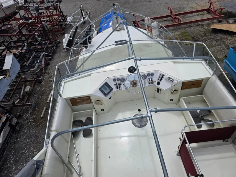 Slide: The Image of 1988 Marinette 37 Motor Yacht cockpit with steering wheel, controls, and seating, viewed from above. - 9
