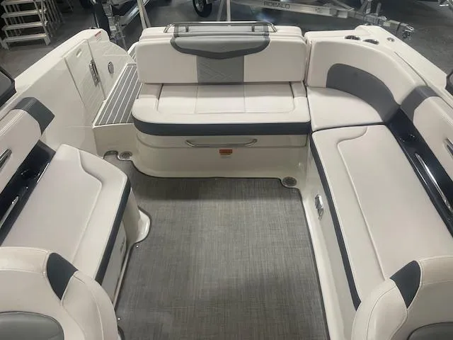 Slide: The Image of 2018 Chaparral 267 SSX boat interior with white and gray seating arrangement. - 11