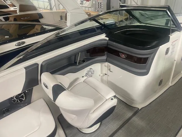 Slide: The Image of 2018 Chaparral 267 SSX boat interior with sleek seating and modern dashboard design. - 14