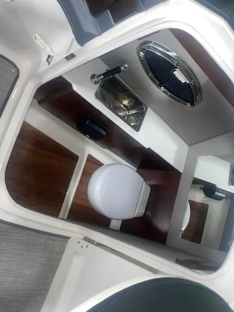 Slide: The Image of 2018 Chaparral 267 SSX boat interior with sink and toilet. - 15