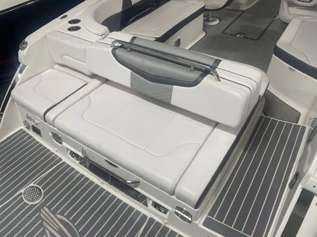 Slide: The Image of 2018 Chaparral 267 SSX boat interior with white seating and gray flooring. - 16