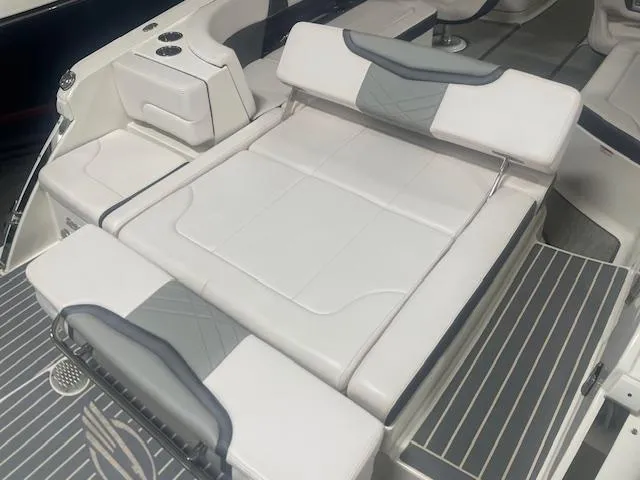 Slide: The Image of 2018 Chaparral 267 SSX boat interior with white cushioned seating and sleek design. - 17
