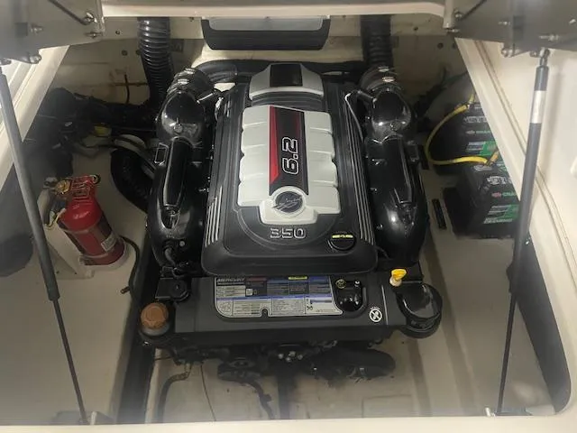 Slide: The Image of Engine compartment of 2018 Chaparral 267 SSX with 6.2L engine and fire extinguisher. - 18
