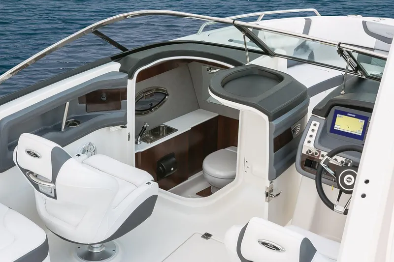 Slide: The Image of Manufacturer Provided Image: 2018 Chaparral 267 SSX boat interior with helm, seating, and cabin. - 23