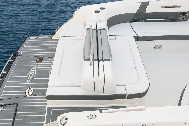 Slide: The Image of Manufacturer Provided Image: 2018 Chaparral 267 SSX boat with white and gray seating, near water. - 26