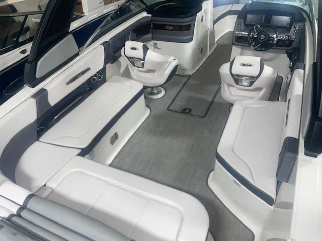 Slide: The Image of 2018 Chaparral 267 SSX boat interior with white seating and modern dashboard. - 9