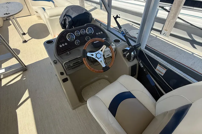 Slide: The Image of Interior of 2016 Custom King Mariner boat with steering wheel and control panel. - 12