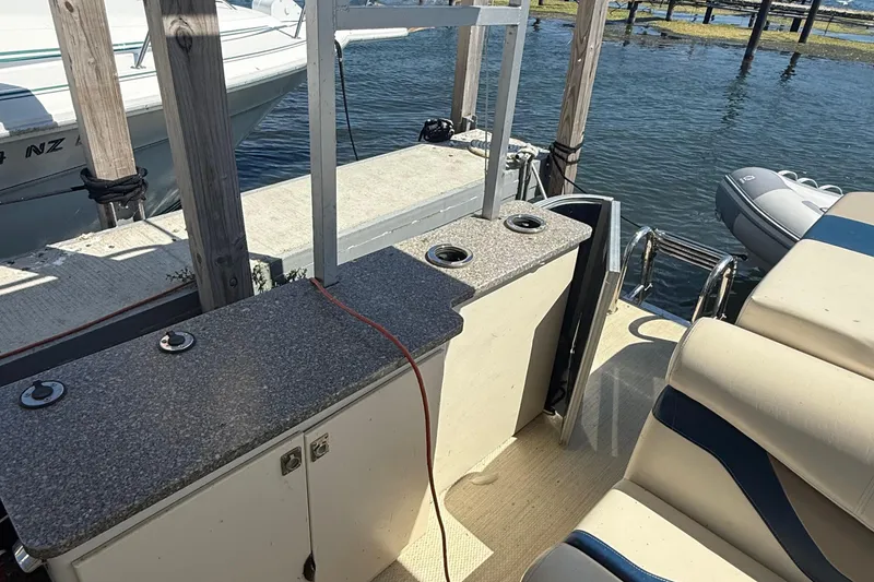 Slide: The Image of Boat interior with seating and counter, 2016 Custom King Mariner, docked by the water. - 13