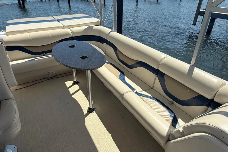 Slide: The Image of Luxurious seating area on 2016 Custom King Mariner boat with table, overlooking water. - 14