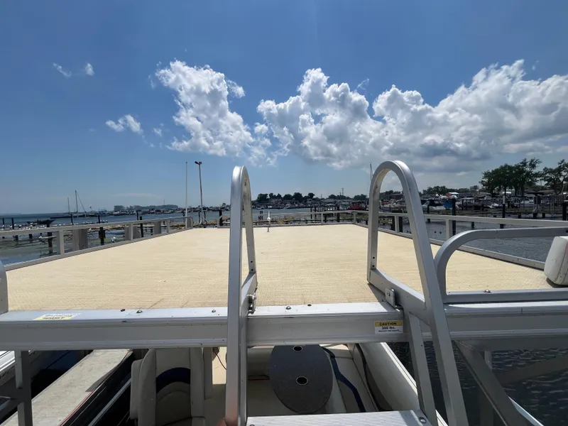 Slide: The Image of Custom King Mariner boat deck with clear sky and waterfront view, 2016 model. - 18