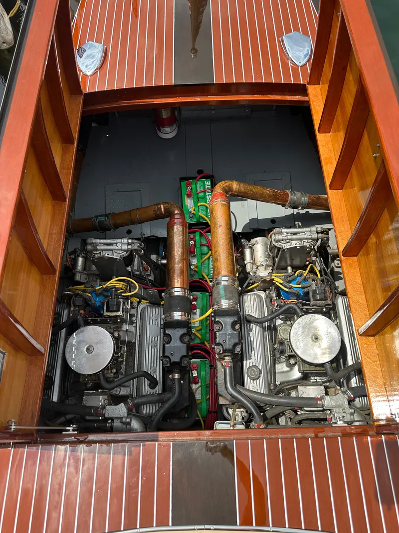 Slide: The Image of Engine compartment of a 1999 Hacker-Craft Custom Sport boat, showcasing dual engines. - 18