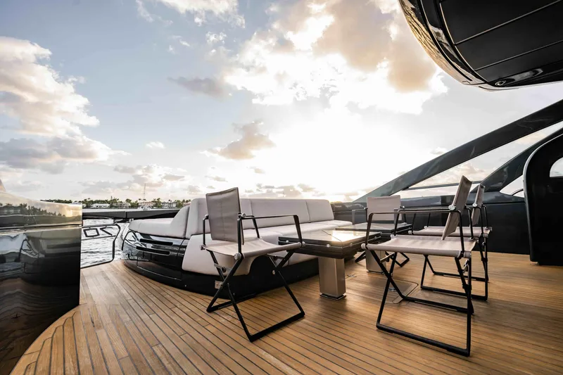 Slide: The Image of Luxurious 2017 Pershing 70 yacht deck with seating, sunset view, and elegant design. - 11