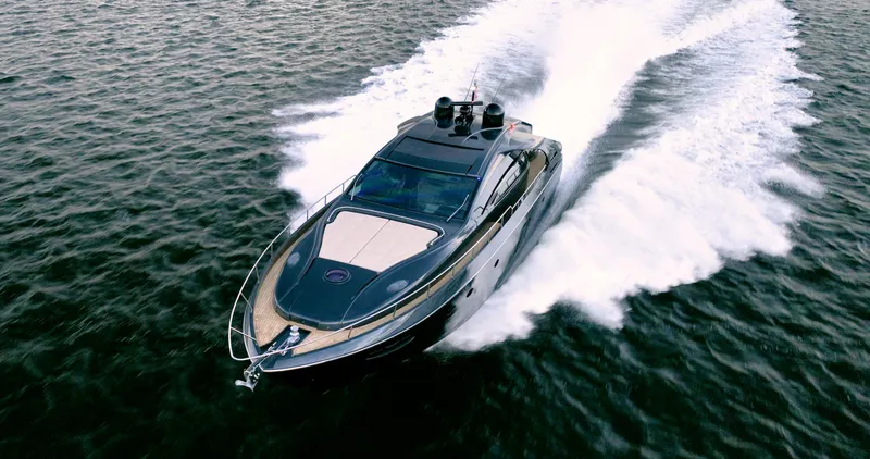 Slide: The Image of 2017 Pershing 70 yacht cruising swiftly on open water. - 2