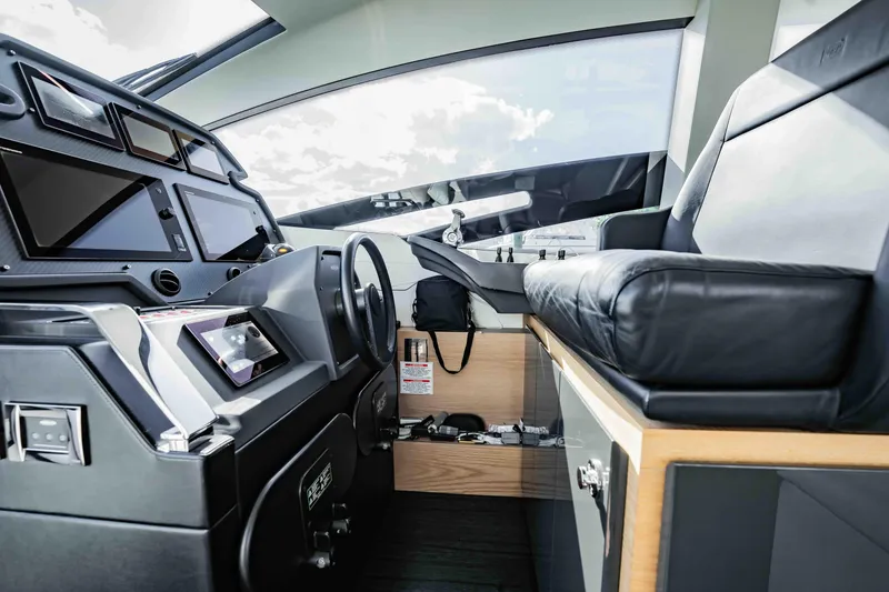Slide: The Image of Interior cockpit of 2017 Pershing 70 yacht with modern controls and leather seating. - 22