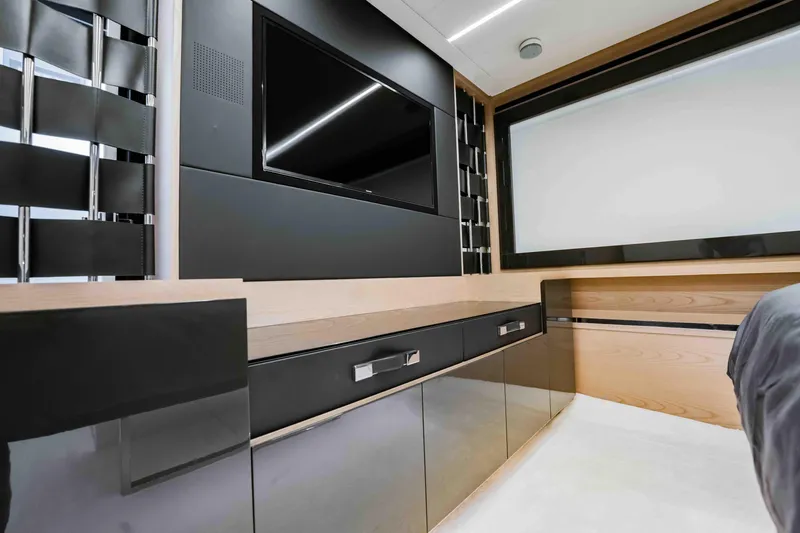 Slide: The Image of Luxurious interior of 2017 Pershing 70 yacht with sleek black cabinetry and modern TV setup. - 27