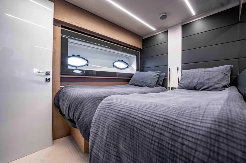 Slide: The Image of Luxurious twin bedroom in 2017 Pershing 70 yacht with modern design and cozy bedding. - 38
