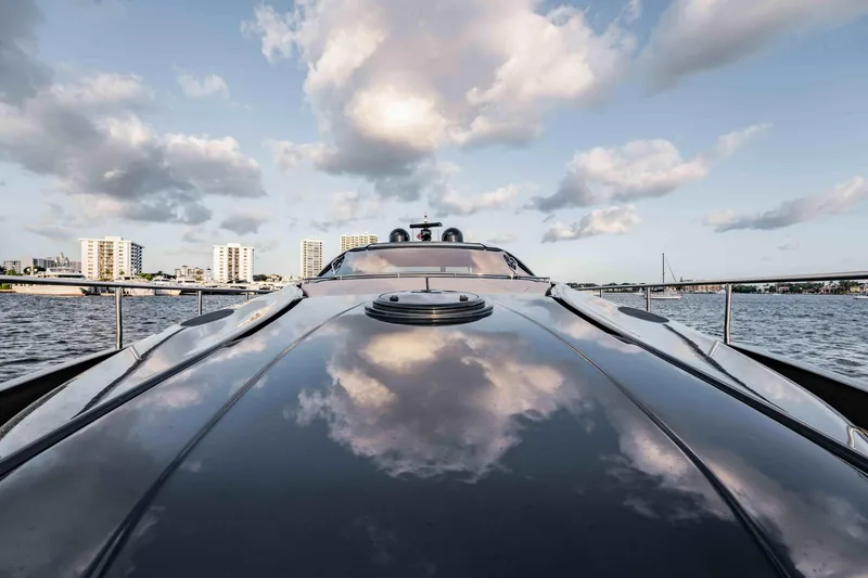 Slide: The Image of 2017 Pershing 70 yacht reflecting clouds, cruising near city skyline. - 41